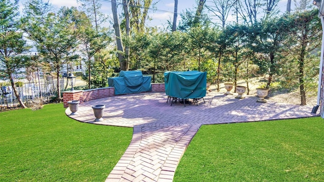 view of patio with grilling area and fence