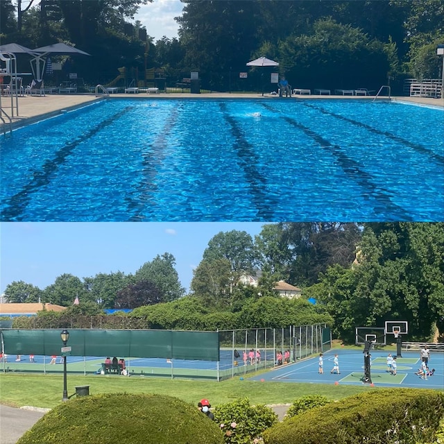 view of swimming pool with community basketball court and fence