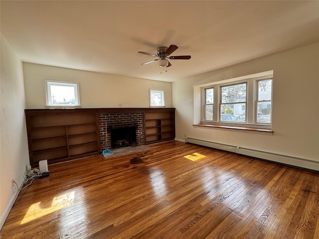 unfurnished living room with ceiling fan, a fireplace, wood finished floors, baseboards, and baseboard heating