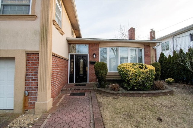 doorway to property with stucco siding and brick siding