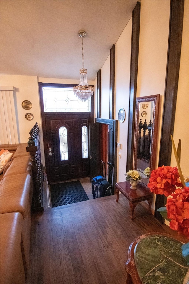 foyer entrance featuring a chandelier, hardwood / wood-style floors, and a high ceiling