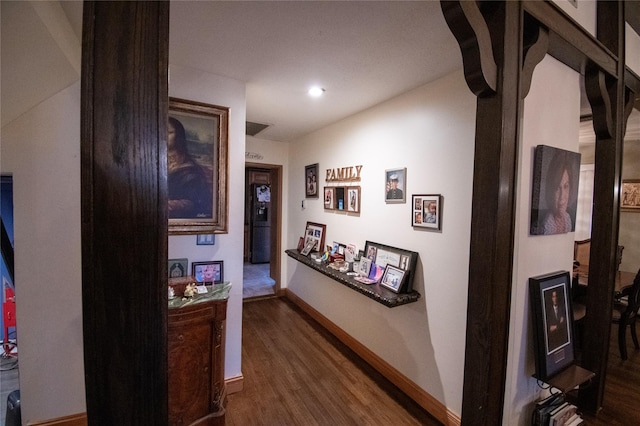 hall with wood finished floors and baseboards