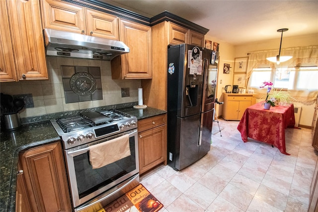 kitchen featuring stainless steel gas range oven, under cabinet range hood, backsplash, black refrigerator with ice dispenser, and pendant lighting