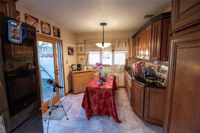 kitchen featuring a sink, visible vents, french doors, dark countertops, and pendant lighting