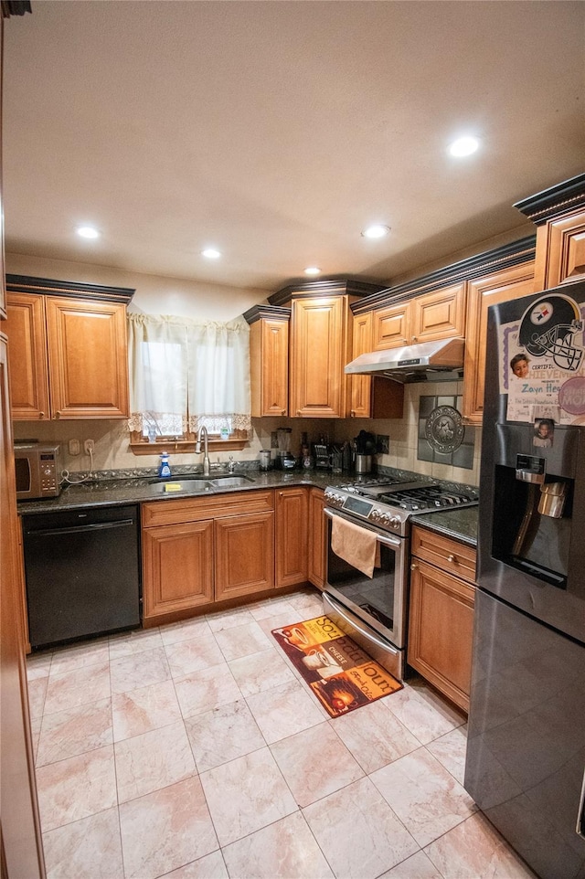 kitchen featuring under cabinet range hood, stainless steel appliances, a sink, backsplash, and brown cabinets