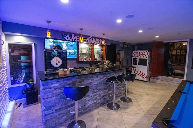 bar with light tile patterned floors, a dry bar, recessed lighting, and refrigerator