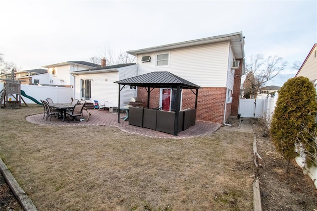 rear view of property featuring fence, an outdoor living space, a playground, and brick siding