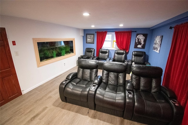 cinema room featuring baseboards, wood finished floors, and recessed lighting