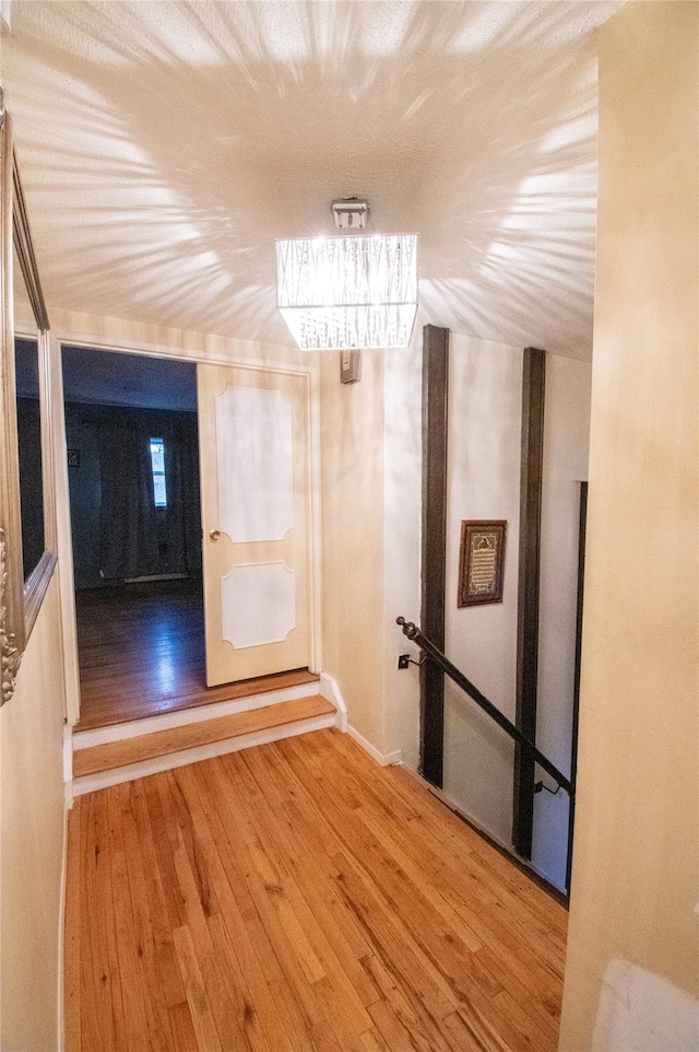 hallway with hardwood / wood-style flooring