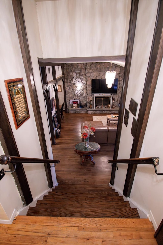 stairs featuring baseboards and wood finished floors