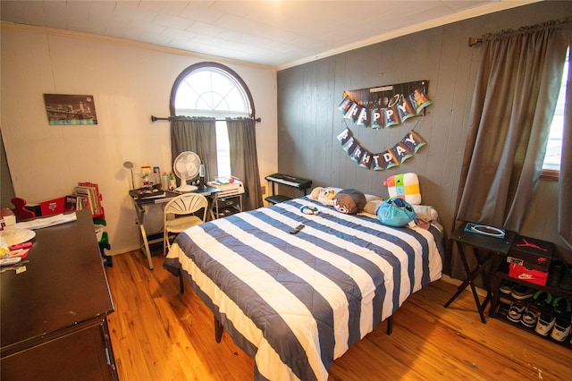 bedroom featuring crown molding and wood finished floors