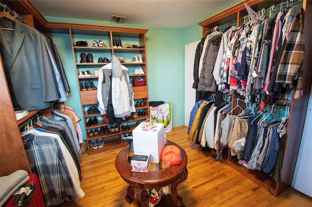 walk in closet featuring wood finished floors and visible vents