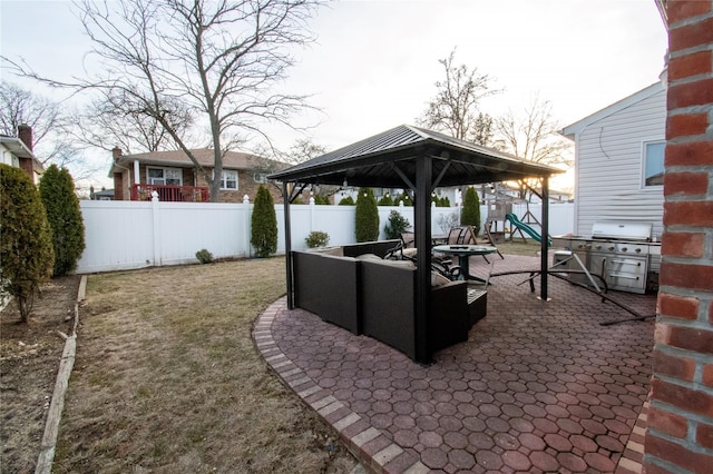 view of patio / terrace with a fenced backyard, a playground, area for grilling, and an outdoor hangout area