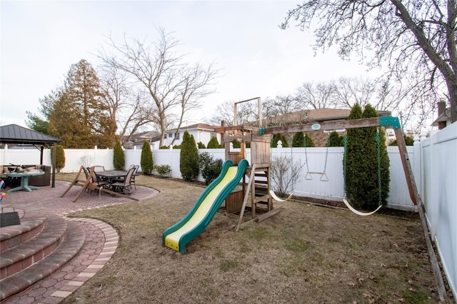 view of play area with a fenced backyard and a gazebo