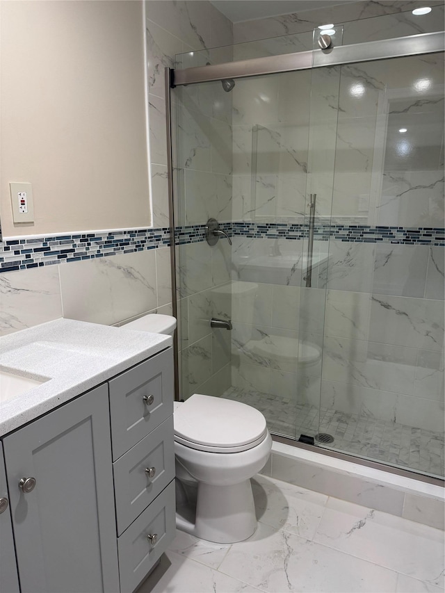 full bath with toilet, marble finish floor, a shower stall, and vanity