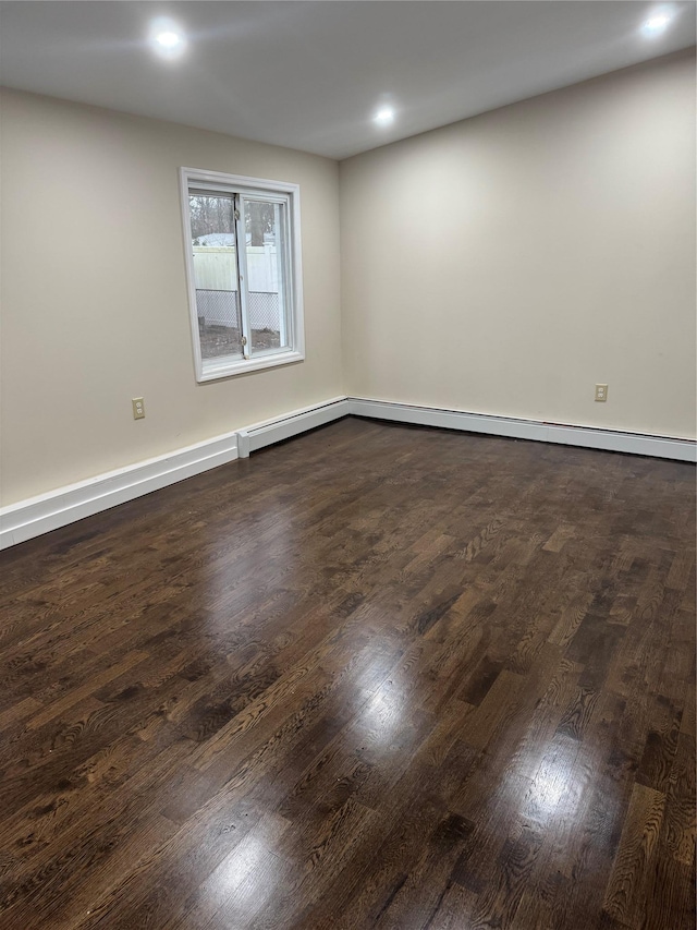 spare room featuring dark wood-type flooring, recessed lighting, and baseboards