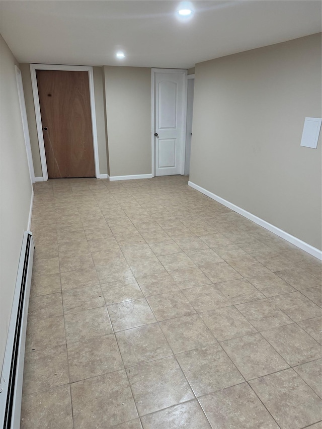 interior space featuring a baseboard heating unit, recessed lighting, and baseboards