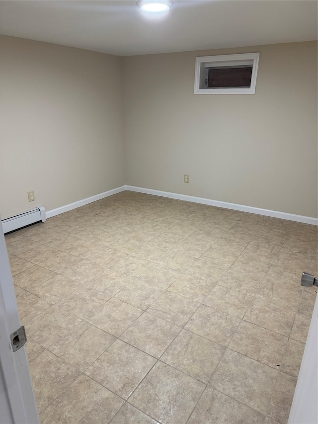 empty room with a baseboard radiator and baseboards