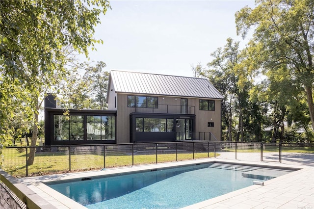 view of swimming pool with a lawn, fence, and a fenced in pool