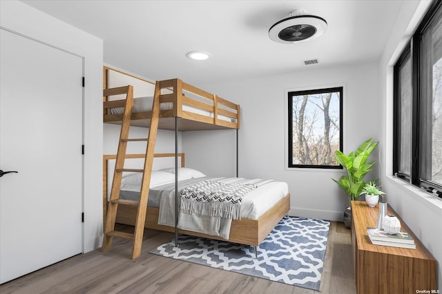 bedroom with recessed lighting, visible vents, and wood finished floors