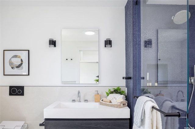 bathroom featuring walk in shower and vanity