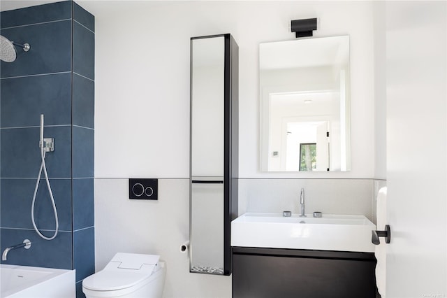 bathroom featuring tile walls, toilet, vanity, shower / washtub combination, and backsplash