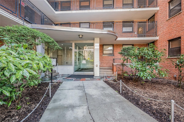 doorway to property featuring brick siding