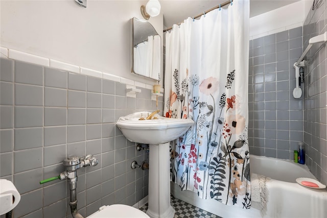 full bathroom featuring tile walls and shower / bathtub combination with curtain