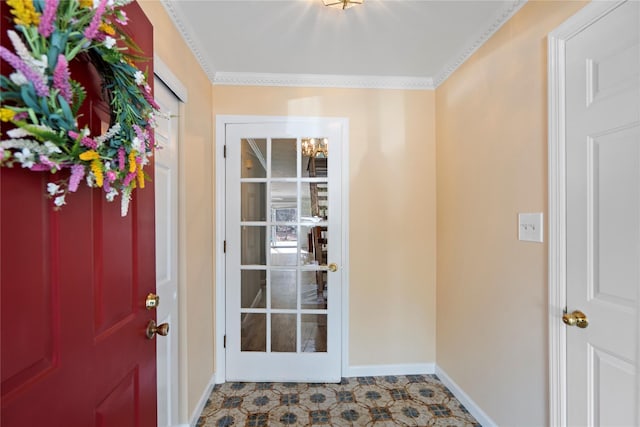 foyer with ornamental molding and baseboards