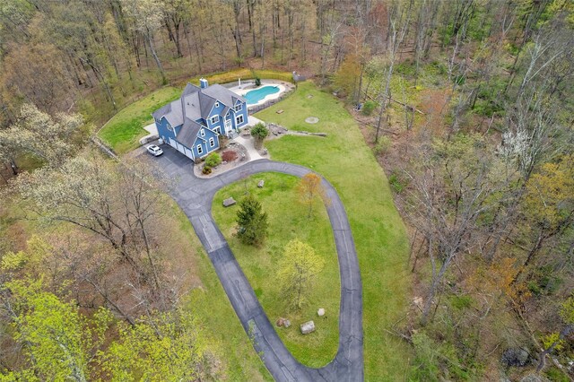 birds eye view of property with a view of trees