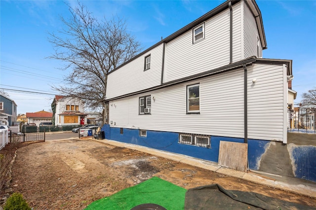 view of side of property featuring fence