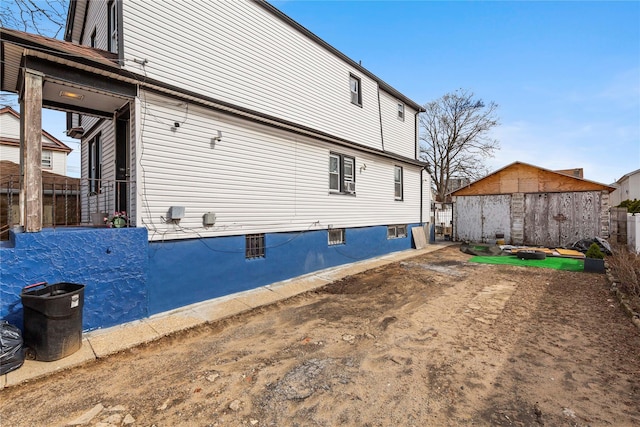 view of home's exterior with an outdoor structure