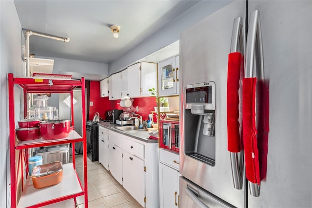 kitchen with white cabinetry, black range with gas cooktop, light tile patterned flooring, and stainless steel fridge with ice dispenser