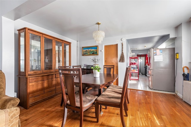 dining room with a chandelier and light wood-style flooring