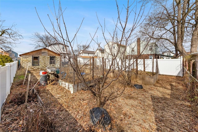 view of yard with a garden and a fenced backyard