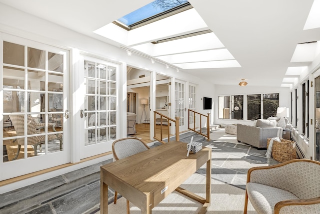 sunroom / solarium featuring french doors and a skylight