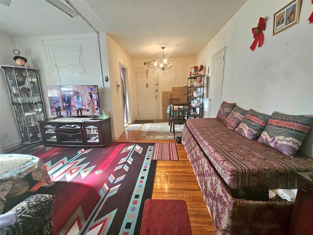 living area with a chandelier and wood finished floors