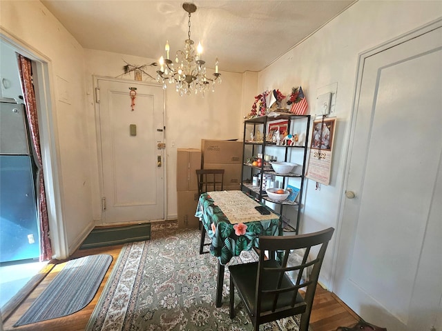 dining room featuring a notable chandelier and wood finished floors