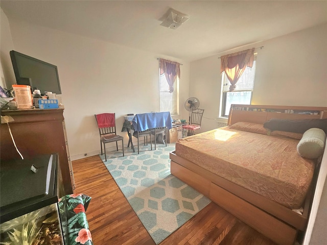 bedroom with wood finished floors and baseboards