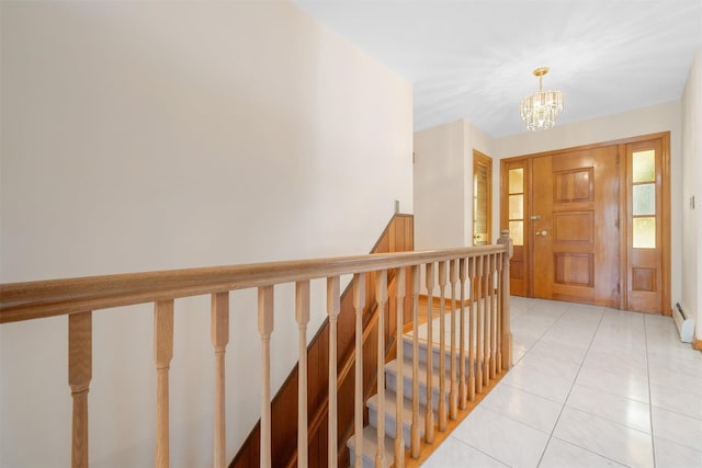 foyer entrance with a chandelier and light tile patterned flooring