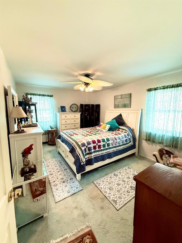 carpeted bedroom featuring a ceiling fan