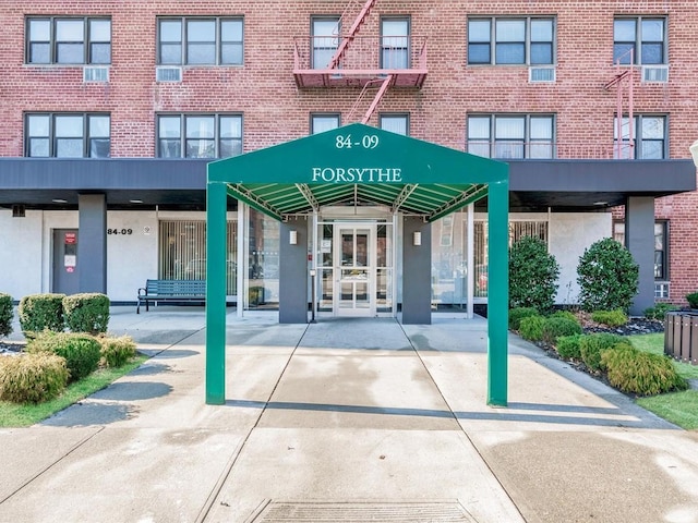 entrance to property featuring brick siding