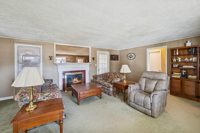 living area with a textured ceiling, carpet, a fireplace, and baseboards