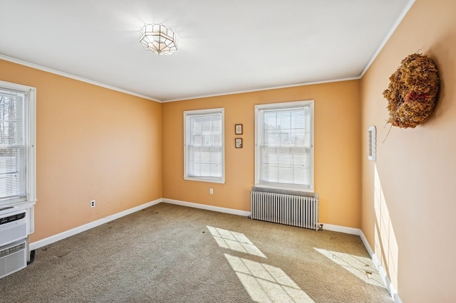 carpeted spare room featuring ornamental molding, baseboards, and radiator heating unit