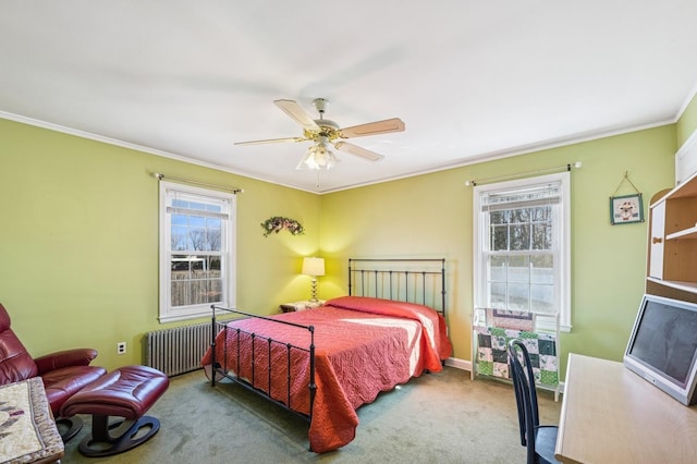 bedroom featuring crown molding, radiator, carpet flooring, ceiling fan, and baseboards