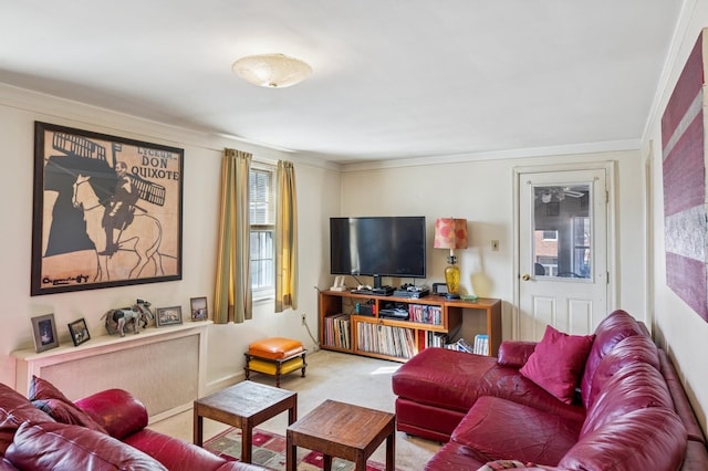 living room with ornamental molding and carpet