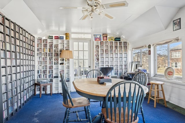 sunroom featuring lofted ceiling and a ceiling fan