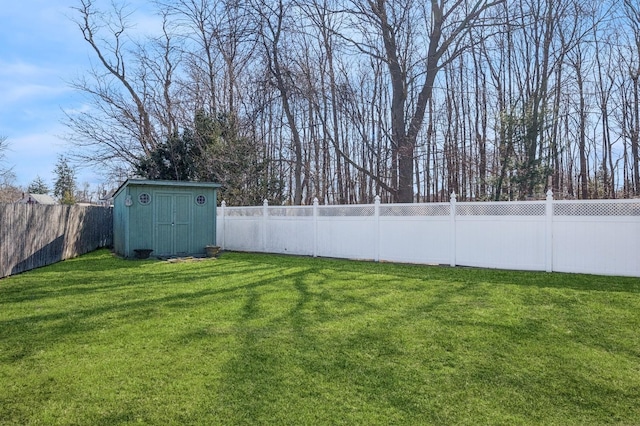 view of yard with a fenced backyard, an outdoor structure, and a storage shed