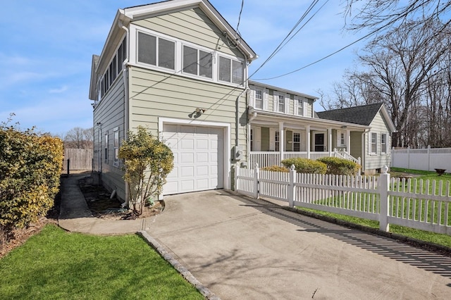 view of front of house with covered porch, concrete driveway, a fenced front yard, and a garage