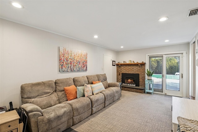 carpeted living area with a brick fireplace, recessed lighting, visible vents, and ornamental molding